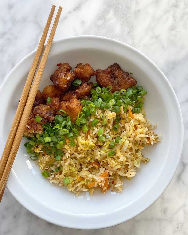 Last of the Super Bowl fried cauliflower tossed with some soy sauce and bottled sweet chili sauce. “Fried” (sautéed at best) rice with cabbage and carrot…