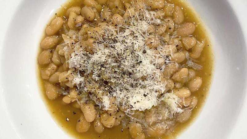 photo of completed recipe: One thing that makes it on the menu almost every week: beans. This week was cannellini cooked in chicken stock, topped with parm and served with a shredded…