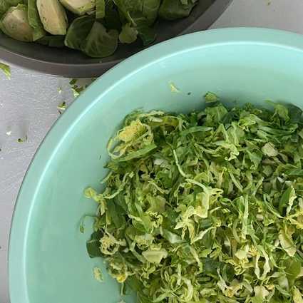 Shred the other half of the Brussels sprouts with a mandolin (use a [safety glove](https://www.foodandwine.com/cooking-techniques/you-need-mandoline-and-cut-proof-glove)!).