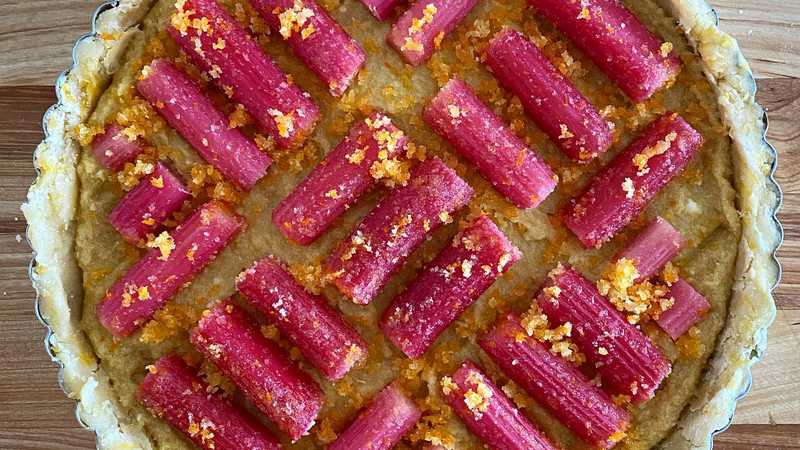 photo of completed recipe: Any fruit would work well here, but the tart rhubarb is especially nice with the pillowy sweet frangipane and tender crust. Orange zest is optional but…