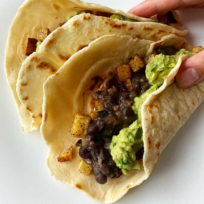 One of those accidentally vegan meals. Sweet potato and black bean tacos with fresh guac on homemade flour tortillas. I could eat this every day.