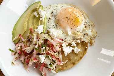 Breakfast tostada with cabbage and radish slaw